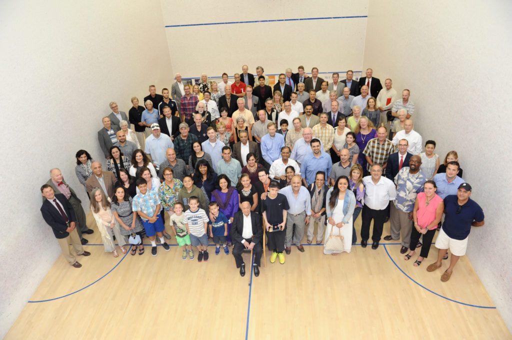 Hashim Khan memorial service attendees surrounding Hashim's brother, Azam (sitting front, center). 